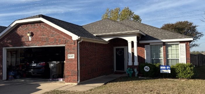 Home with new architectural shingle roof and high-profile ridge cap