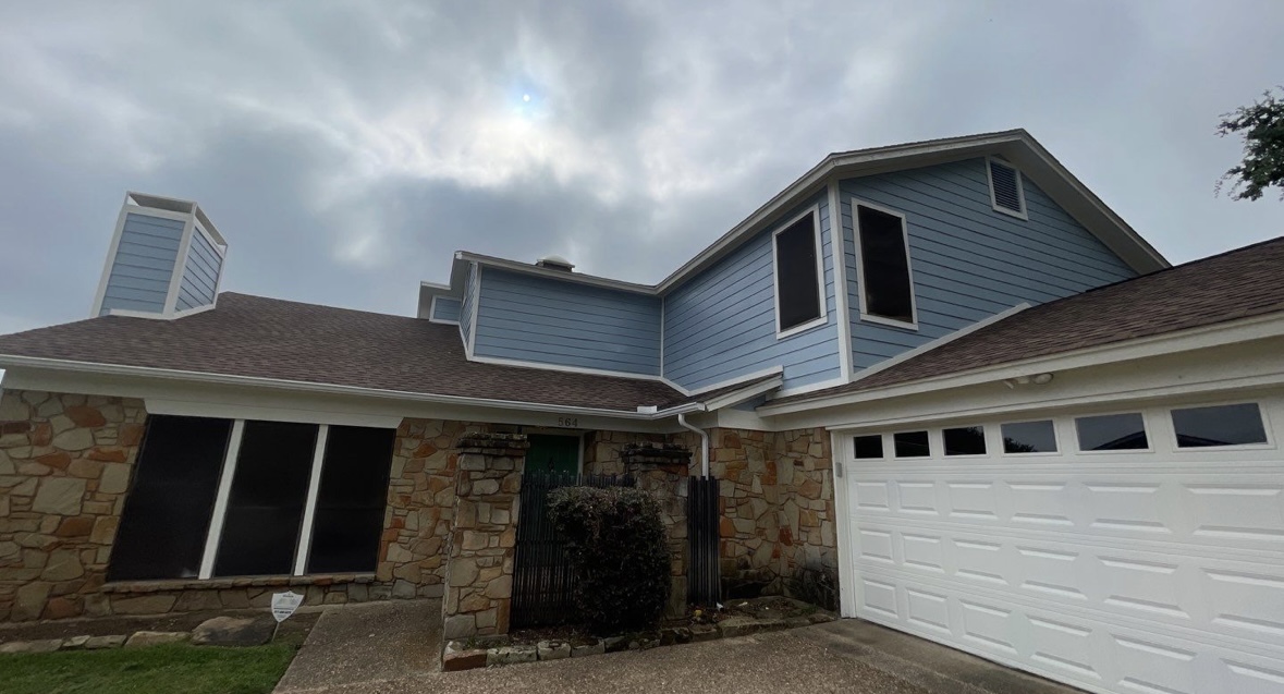 Home exterior after renovation with modern blue siding