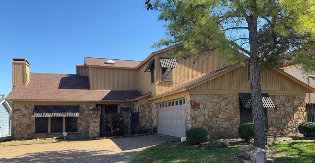 Home exterior before renovation with tan siding