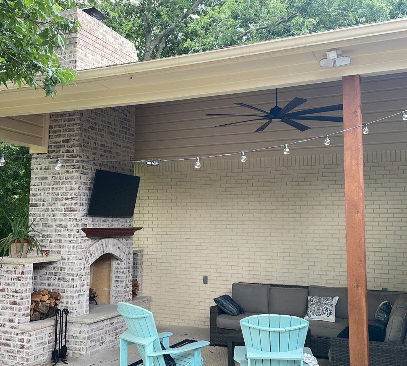 Completed covered patio with furniture and lighting
